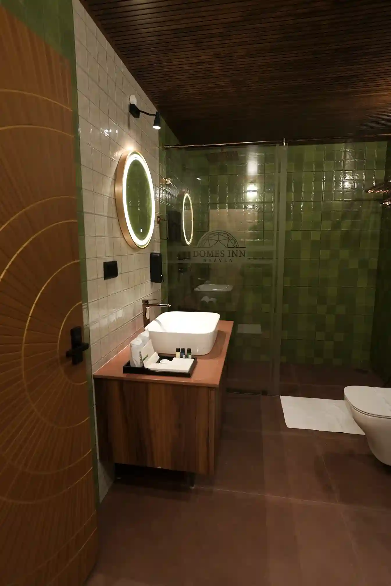 Spacious bathroom with toiletries and hair dryer at Domes Inn Heaven